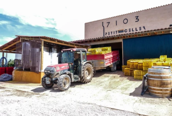 Imatge de Celler 7103 amb tractor en verema a la porta del celler