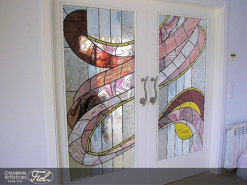 Leaded stained glass. It was made for a particular client based on the original design and preferences of our client who, with our suggestions, chose the colors and glass samples. A perfect combination with the whites of the door and the wall.