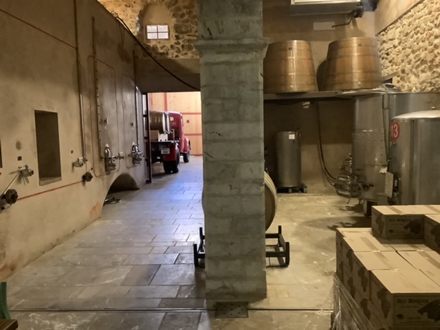 On the left of the image the concrete fermentation tanks